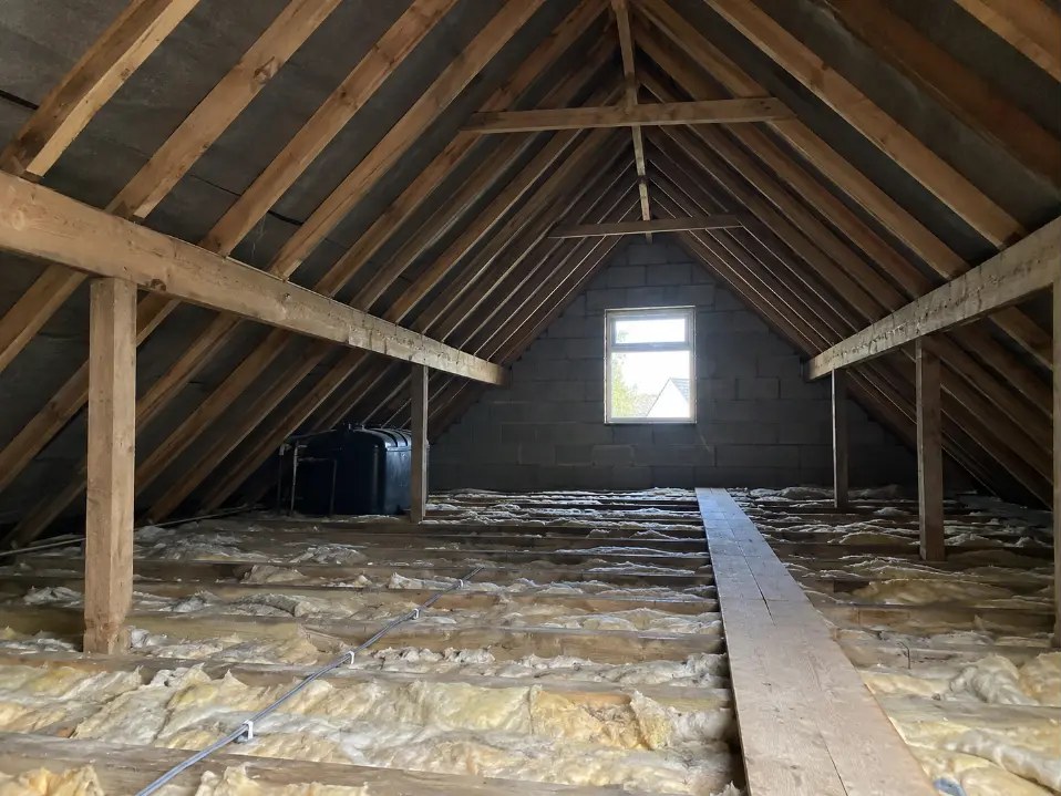 Unused attic with exposed rafters before conversion